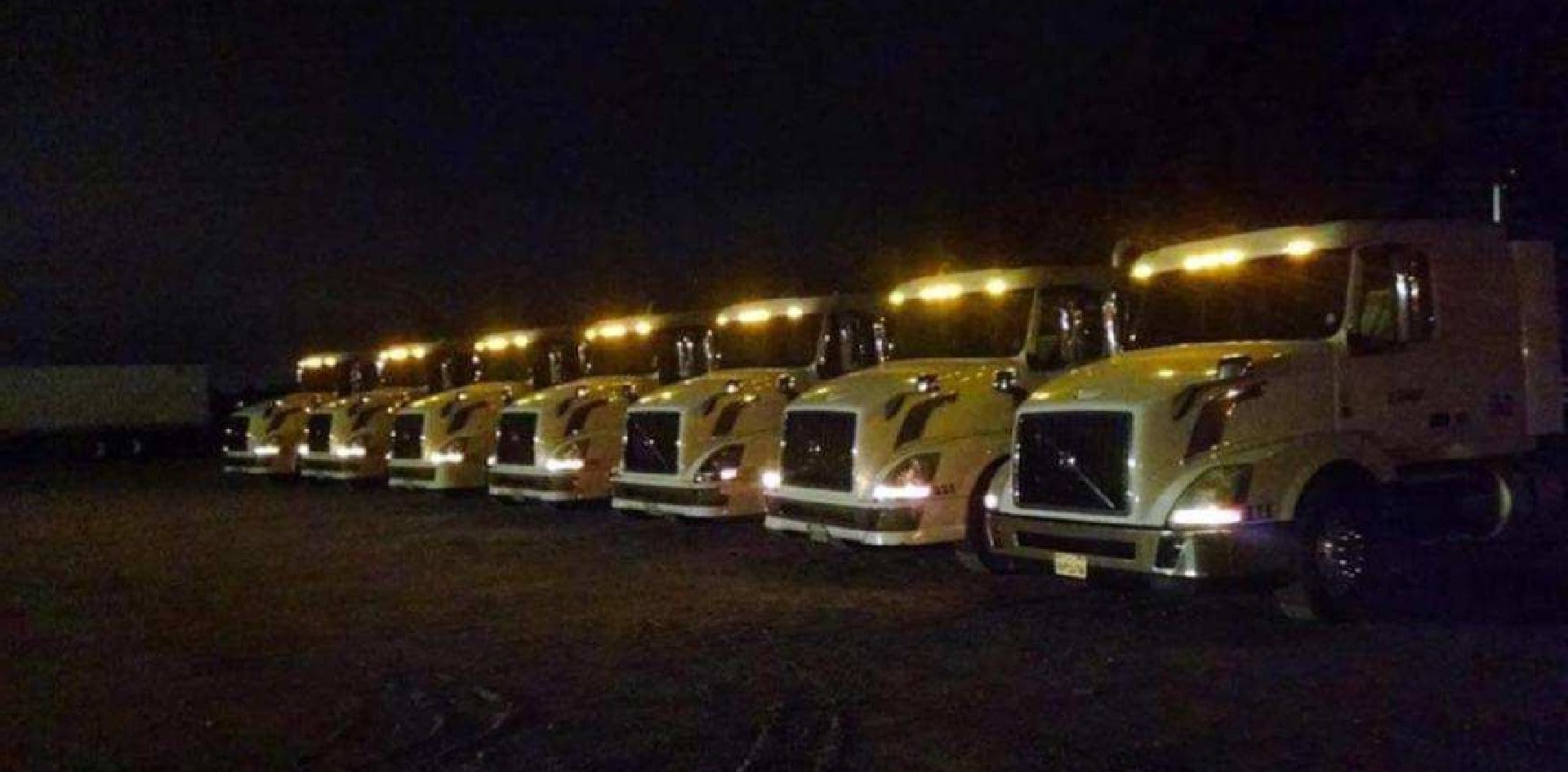 trucks at parking lot during night